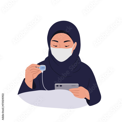 Muslim Woman Using a Health Monitoring Device
