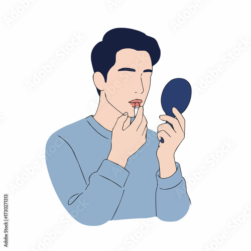 Young man applying lip balm while looking in a hand mirror  