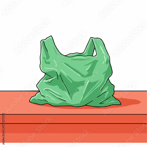 Crumpled green plastic bag resting on orange counter surface  