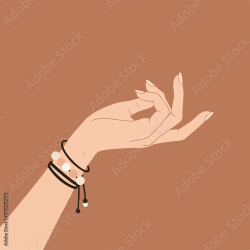 Woman's hand in Jnana mudra pose with beaded bracelets against brown background