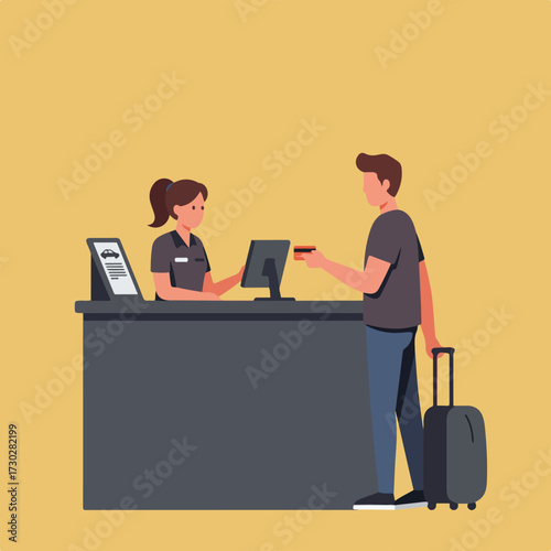 Man with luggage checking-in with credit card at a car rental counter