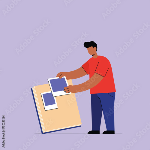 Man placing photos into album against light purple background