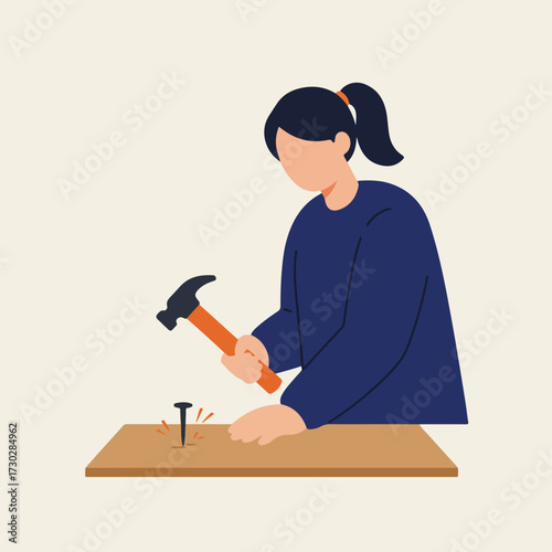 Woman hammers a nail into wood surface