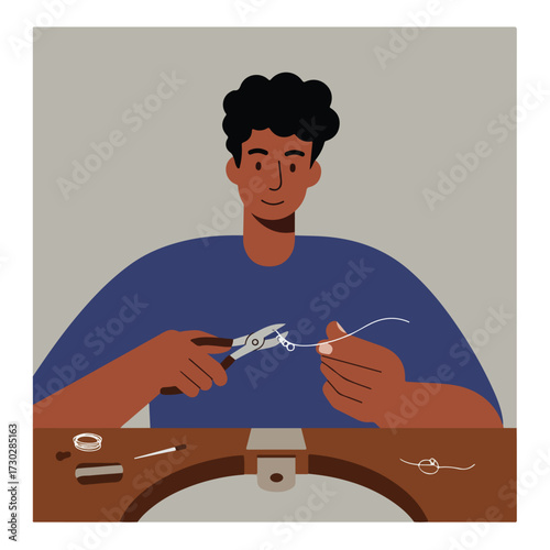 Jeweler creating delicate wirework jewelry at workbench with tools