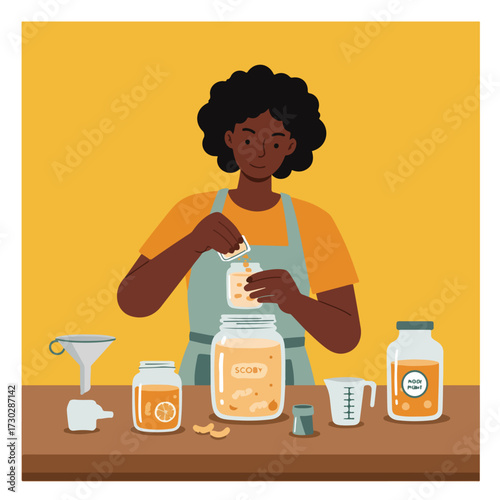 Woman pours contents into jar, making kombucha on a brown surface