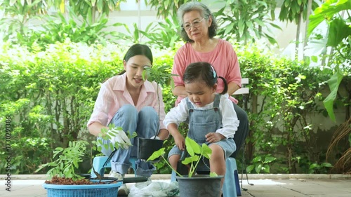 Family planting trees in their home recreational activities, family with young children mother and grandmother working together plant saplings make the home shady and pleasant with green environment.