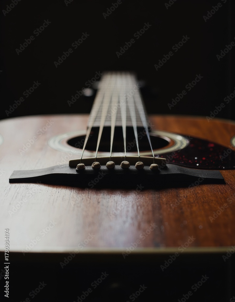 Fototapeta premium Close-up of guitar strings and tuning mechanisms on a wooden body