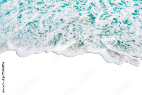 Foamy ocean wave gently rolls onto shore, creating serene and calming scene