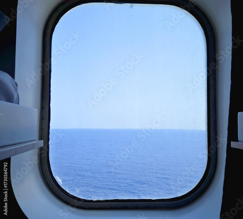 ship's cabin porthole with sea view during summer navigation
