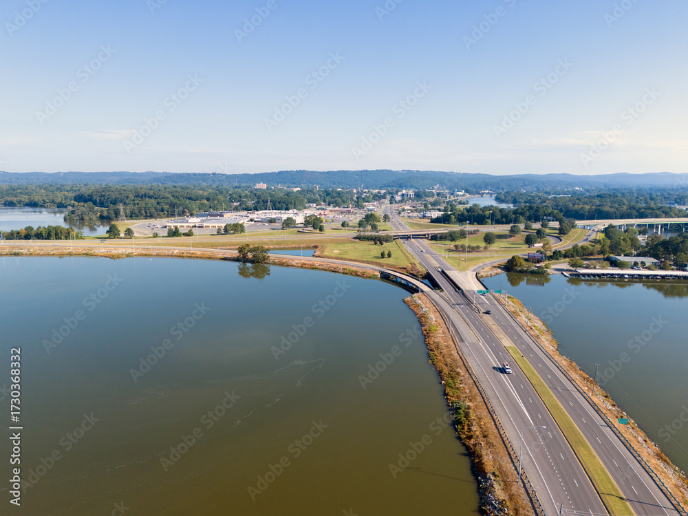 custom made wallpaper toronto digitalAerial View Of Bridge Over Coosa River, Interstate 759 and Highway 411, Lush Forest, And Distant Hillscape Under Clear Sky. The tranquil water reflects the blue sky, creating a scenic landscape.