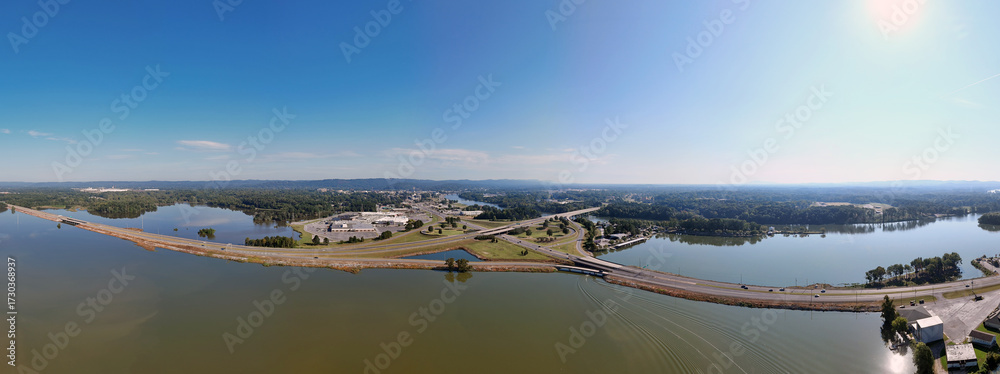 custom made wallpaper toronto digitalAerial View Of Bridge Over Coosa River, Interstate 759 and Highway 411, Lush Forest, And Distant Hillscape Under Clear Sky. The tranquil water reflects the blue sky, creating a scenic landscape.