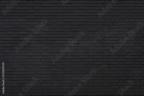 Light black brick wall with textured cracks. Perfect as a background for architectural, urban, or design-related projects.