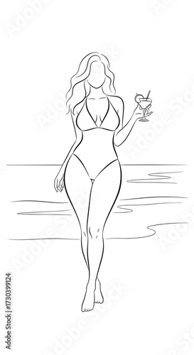 Confident woman in a bikini holding a cocktail while walking on the beach