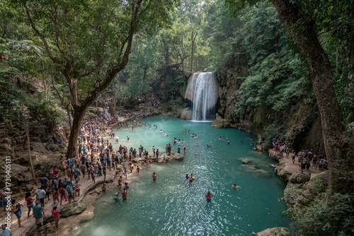 Crowded waterfall pool, lush forest