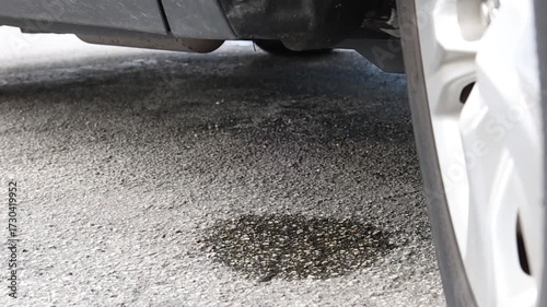 Water condensation from the car’s air conditioner dripping from the drainage tube under the vehicle