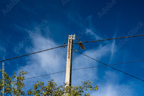 Led street light on electricity post , dark blue sky with white clouds background.