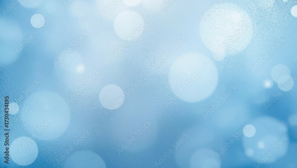 Fototapeta premium Blue and white blurred bokeh effect creates a soft, dreamy background.