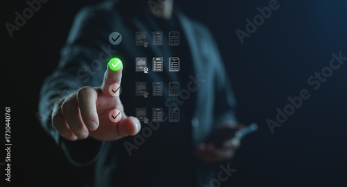 Tableau sur toile Businessman touching virtual checklist interface with green tick mark, representing task management, decision making, quality control, and digital approval process in modern business