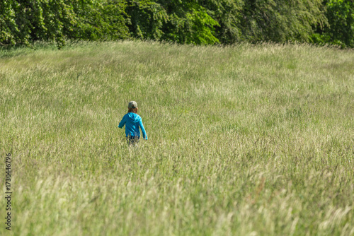 Girl running and jumping in a field