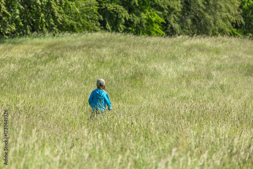 Girl running and jumping in a field