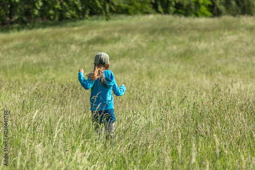 Girl running and jumping in a field