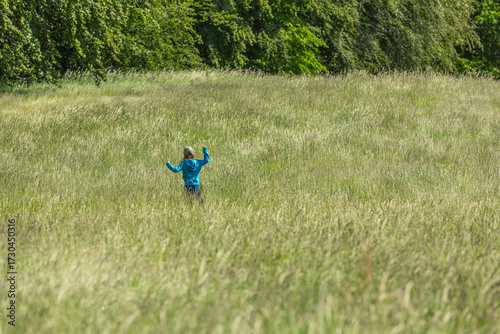 Girl running and jumping in a field
