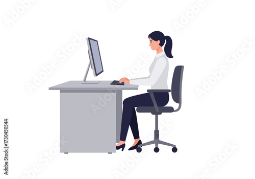 Woman types at computer desk in office wearing a white shirt and ponytail