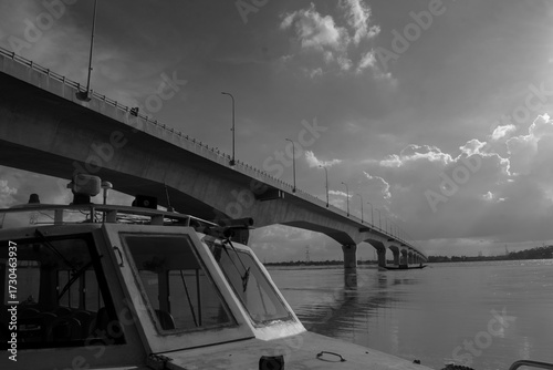 Fototapeta Naklejka Na Ścianę i Meble -  A speedboat on the banks of the Padma River and the Lalon Shah Bridge next to it