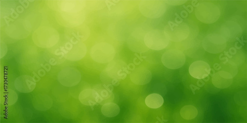 Abstract, soft-focus green bokeh lights create a vibrant, glowing, blurred background effect for a bright spring or summer design