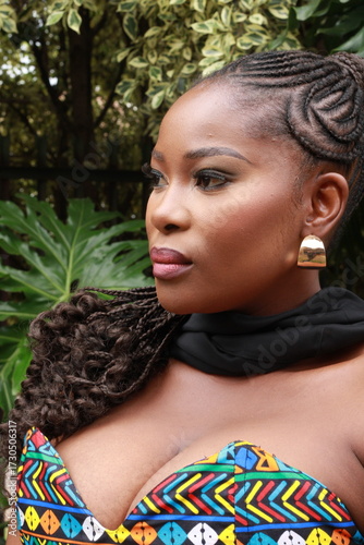 Beautiful African Black Woman with gold earrings  and makeup with braided hair
