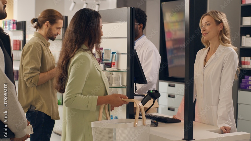 Fototapeta premium Multiracial woman man pharmacy consultants professional healthcare workers pharmacists drugstore indoors serving customers people medicine buying pills vitamins at cashier counter health assisting