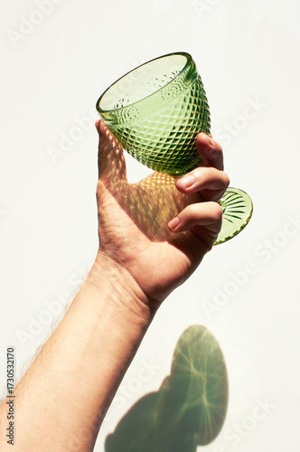 Glass in hand on white back