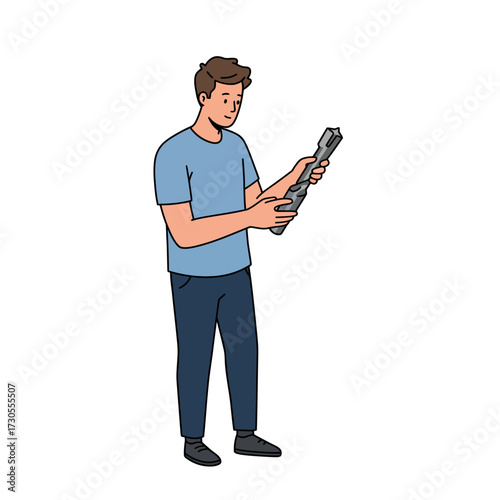 Man in blue shirt holding a long object with both hands and looking down at it carefully