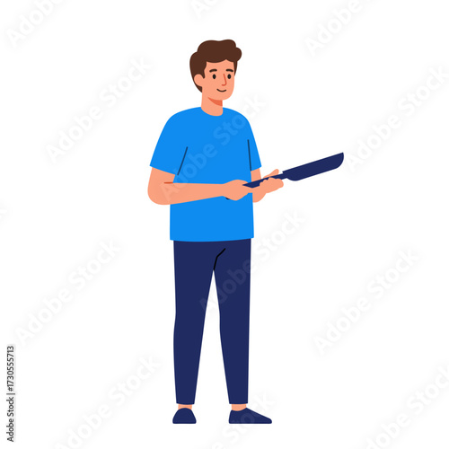 A smiling man in blue holding a cooking pan, ready to prepare food.
