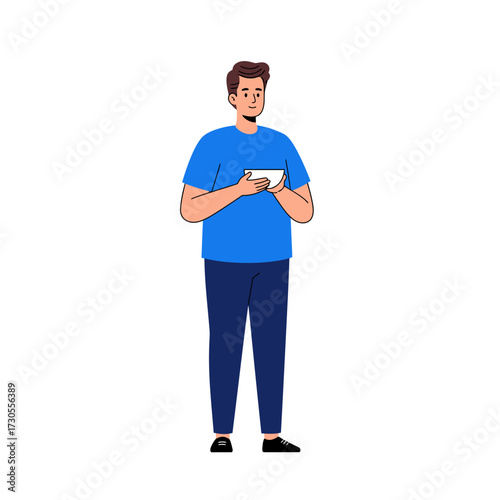 A man in casual attire stands holding a white object, looking thoughtful.