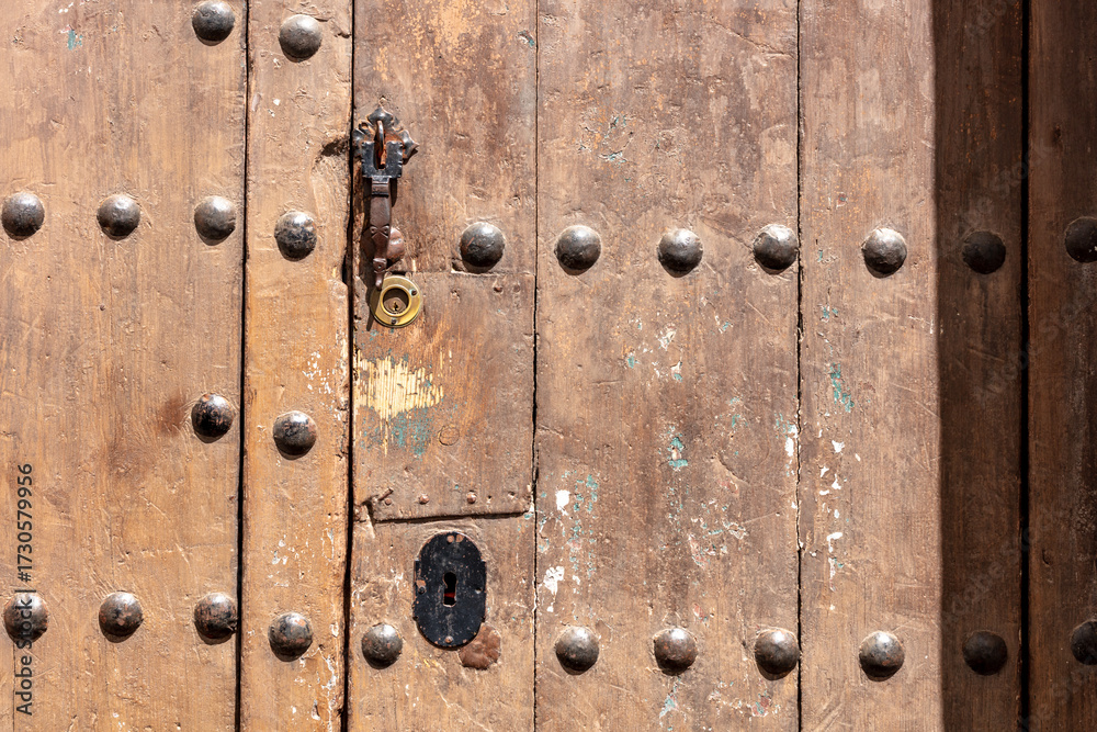 Fototapeta premium Weathered wooden door in Arcos de la Frontera. Andalusia, Spain. 4 September 2025.