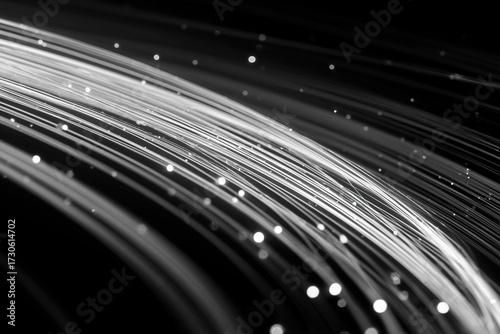 Light trails create a mesmerizing pattern in black and white against a dark background