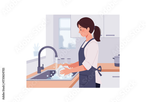 A woman in an apron washes dishes at a kitchen sink next to a window