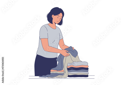 Woman folding clothes stacking them on a table
