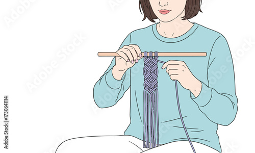 Young woman carefully weaving intricate macrame design, creating beautiful handmade art, perfect for crafting tutorials or creative lifestyle content
