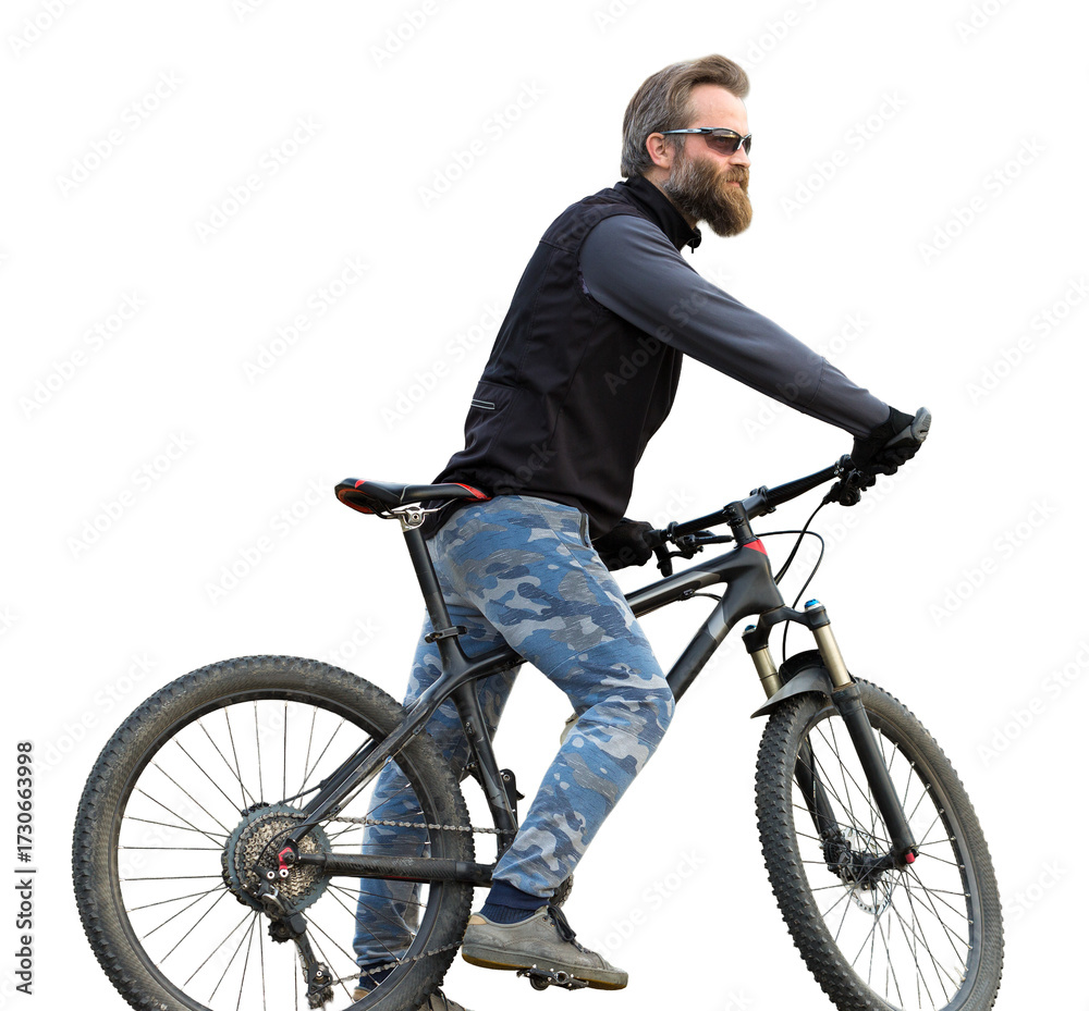 Obraz premium Sports brutal bearded guy on a modern mountain bike. Cyclist on the green hills in the spring.