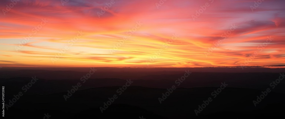 Fototapeta premium Dramatic twilight sky over silhouetted mountain panorama at nightfall, blue hour, evening