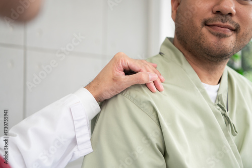 The doctor talks and encourages the patient about treatment options using a digital tablet, promoting clear communication and trust in a bright and supportive hospital environment.