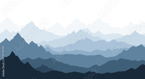 A vast landscape of layered blue mountain ranges fading into a soft white sky.