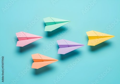 Free Download Colorful Paper Airplanes Arranged on Light Blue Background - GFXLoad