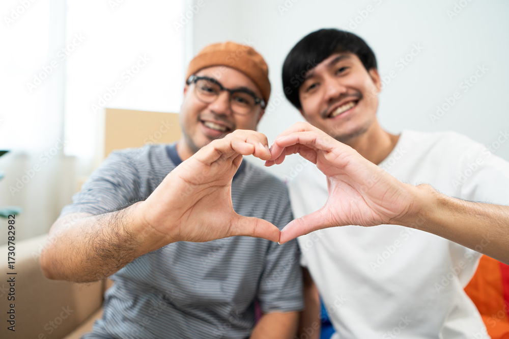 Obraz premium LGBTQIA2S+ couple smile as they build a new life together, a new home, symbolically show love on moving day. A heartwarming moment in our new home, filled with love and understanding.