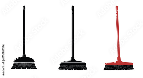 Three cleaning brooms in black and red standing upright on white