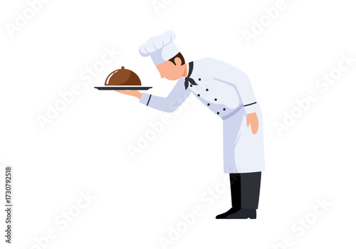 A chef in uniform presents a dish with a dome lid bowing slightly