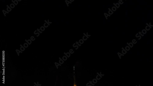 Dynamic slow-motion shot of a firecracker launching skyward at night, emitting brilliant sparks and smoke. Perfect for celebrating events, holidays, and explosive energy.
