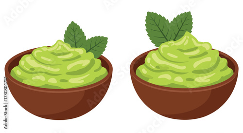 Two servings of vibrant green guacamole with fresh mint garnish displayed